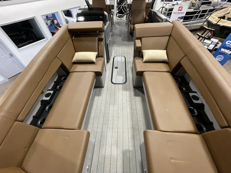 Slide: The Image of Interior of 2025 Balise Horizon 26C boat with brown seating and cup holders. - 25