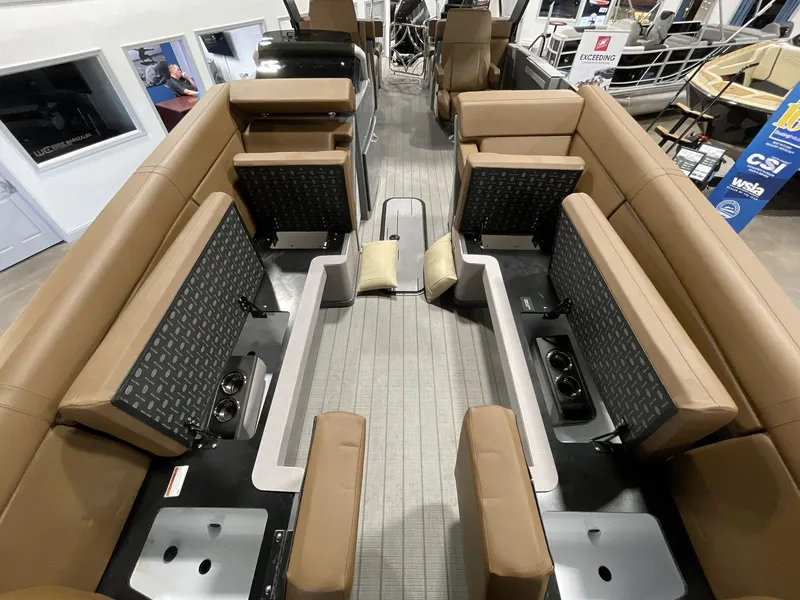 Slide: The Image of Interior of 2025 Balise Horizon 26C boat with tan seating and storage compartments. - 26