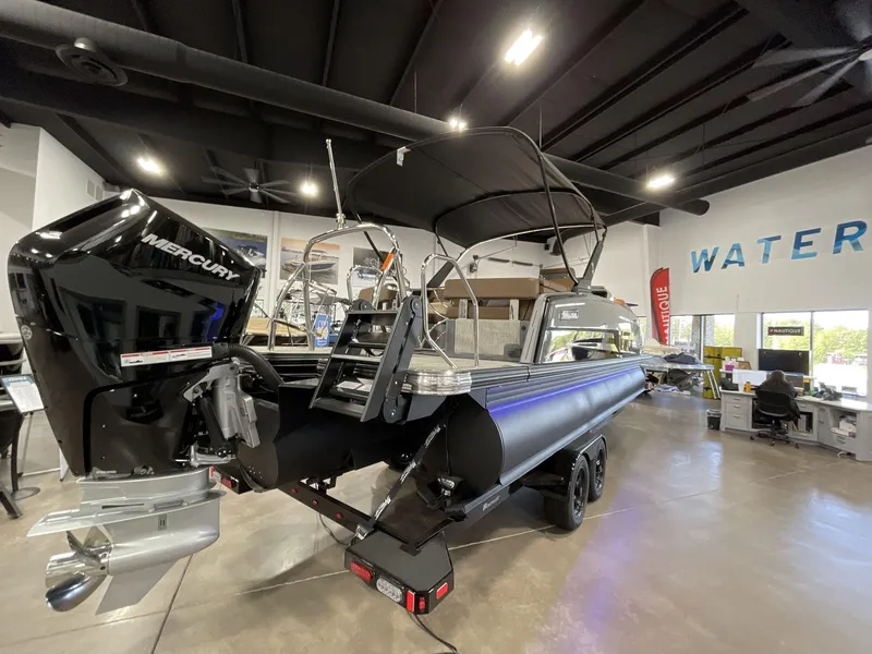 Slide: The Image of 2025 Balise Horizon 26C boat with Mercury engine displayed in showroom. - 6