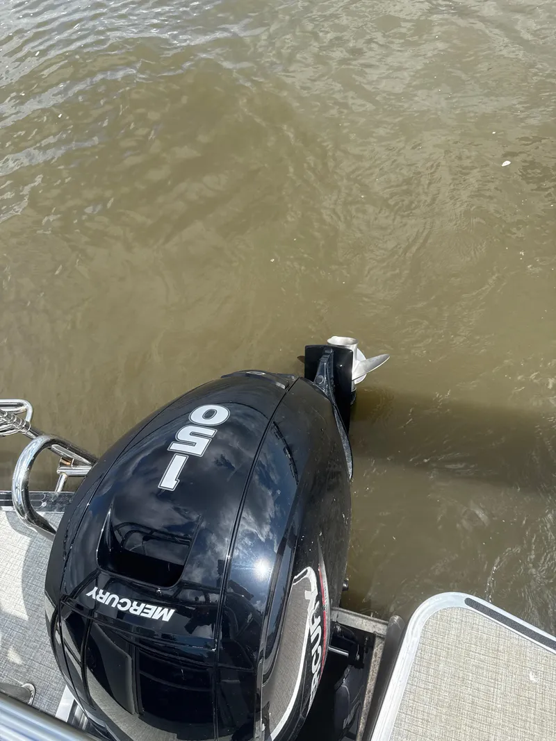 Slide: The Image of 2024 Harris Cruiser 230 with Mercury 150 outboard motor on water. - 5