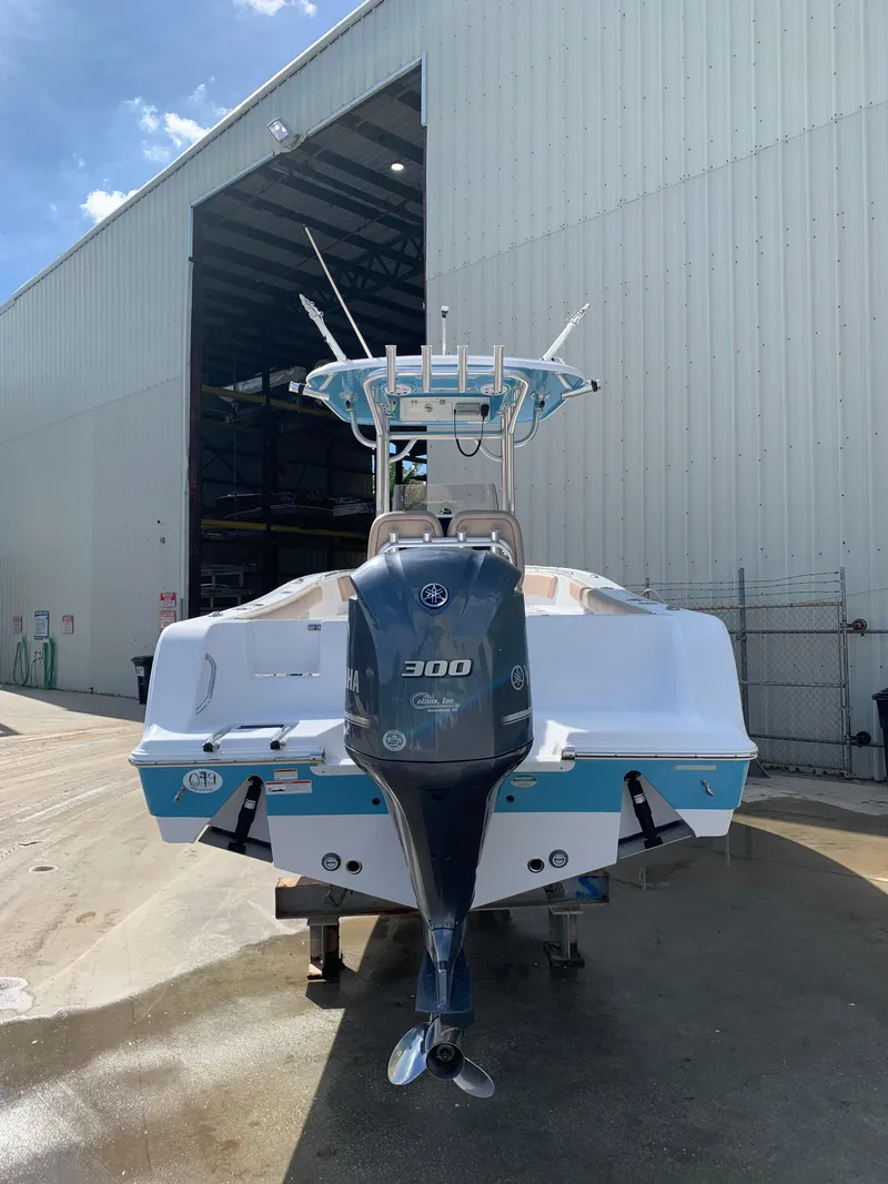 Slide: The Image of 2019 Sportsman Heritage 241 Center Console boat with Yamaha 300 engine outside a warehouse. - 3