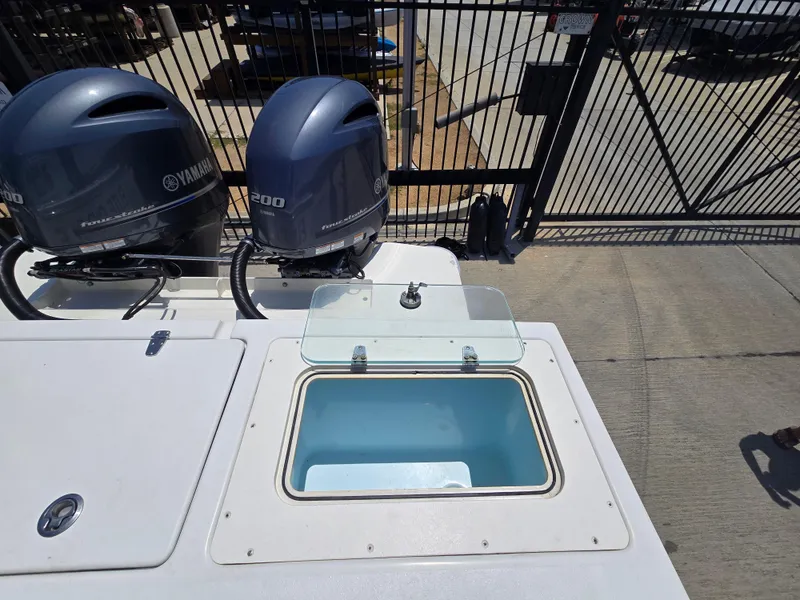Slide: The Image of 2019 Parker 2520 DV boat with Yamaha 200 engines and open storage compartment. - 12