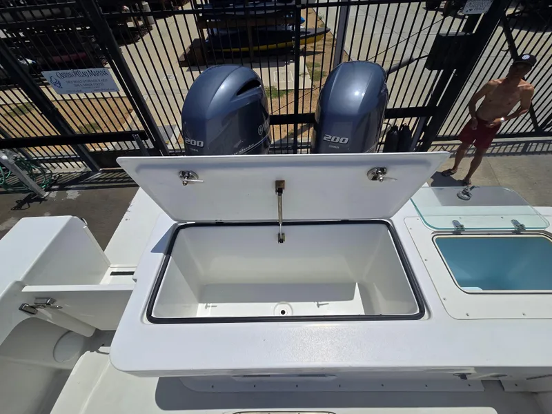Slide: The Image of 2019 Parker 2520 DV boat with open storage compartment and dual Yamaha 200 engines. - 13