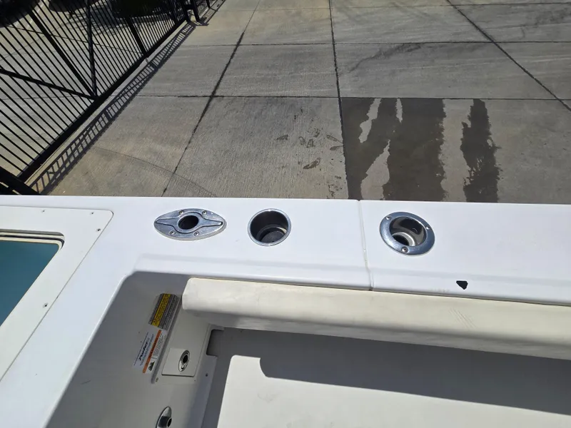 Slide: The Image of 2019 Parker 2520 DV boat deck with rod holders and storage compartment. - 14
