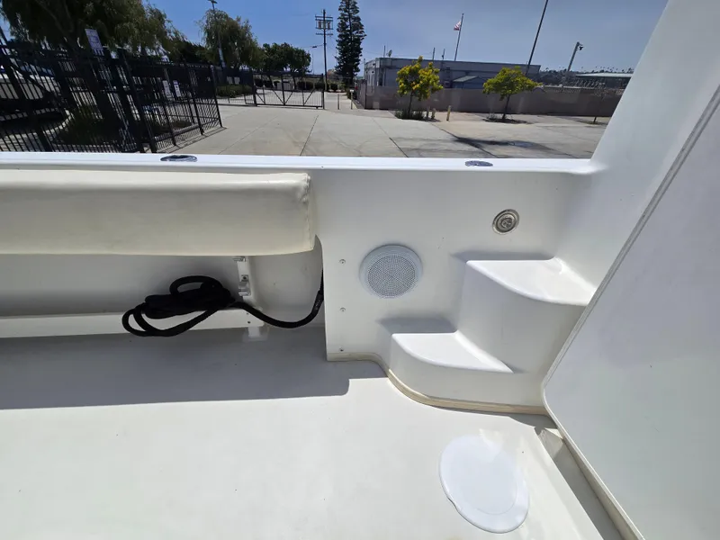 Slide: The Image of Interior view of a 2019 Parker 2520 DV boat, featuring seating and steps. - 16