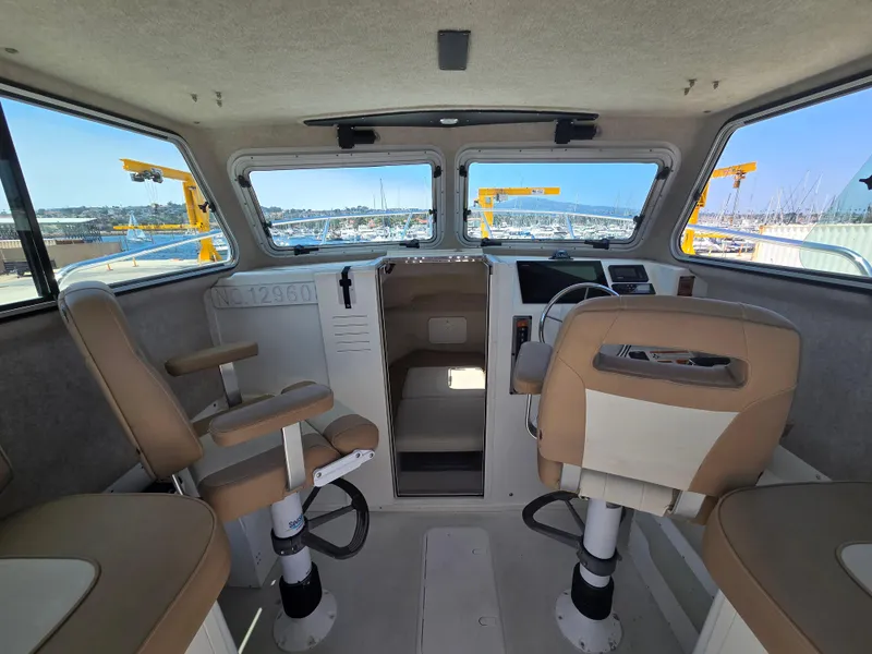 Slide: The Image of Interior of a 2019 Parker 2520 DV boat with seating and control panel. - 18