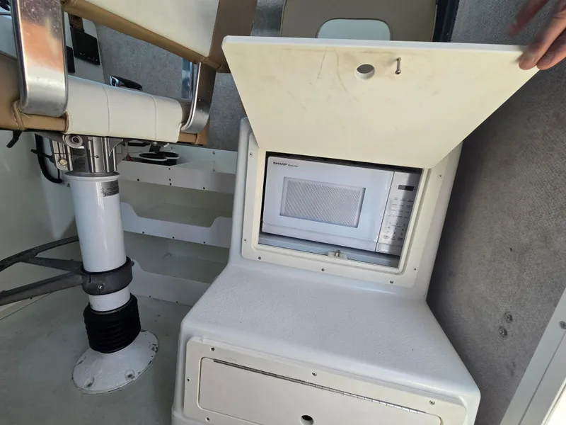 Slide: The Image of Interior of a 2019 Parker 2520 DV boat featuring a built-in microwave. - 23