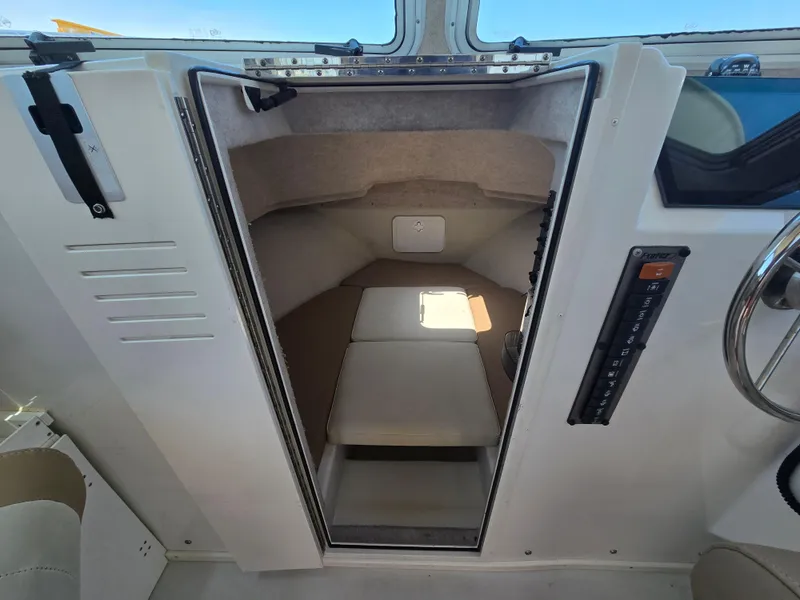 Slide: The Image of 2019 Parker 2520 DV boat cabin interior with seating and control panel. - 28
