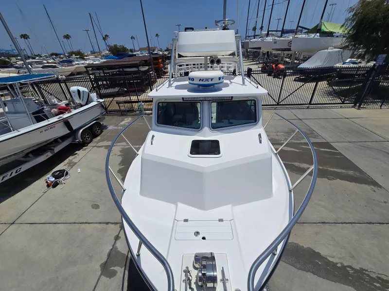 Slide: The Image of 2019 Parker 2520 DV boat docked, surrounded by other vessels and equipment. - 3