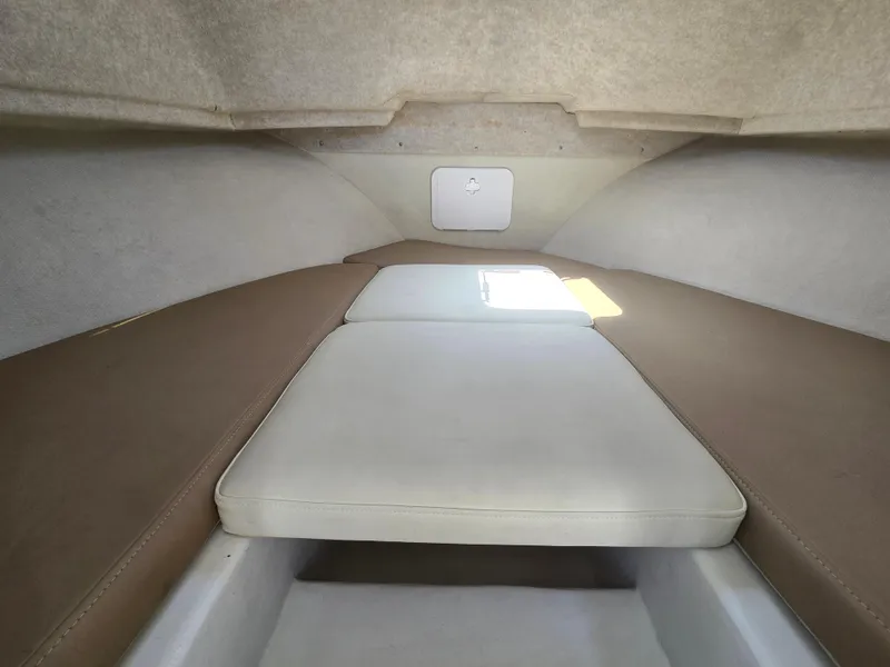 Slide: The Image of Interior cabin of a 2019 Parker 2520 DV boat with cushioned seating. - 31