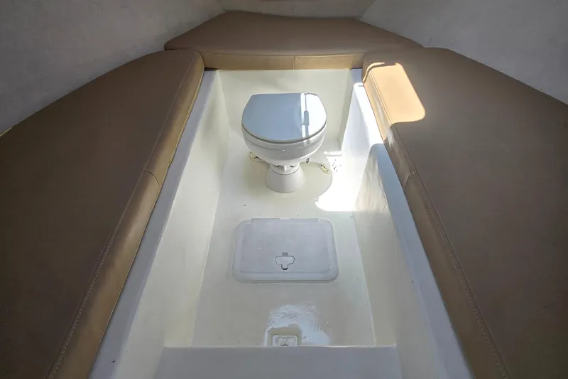 Slide: The Image of Interior of 2019 Parker 2520 DV boat with toilet and cushioned seating. - 32