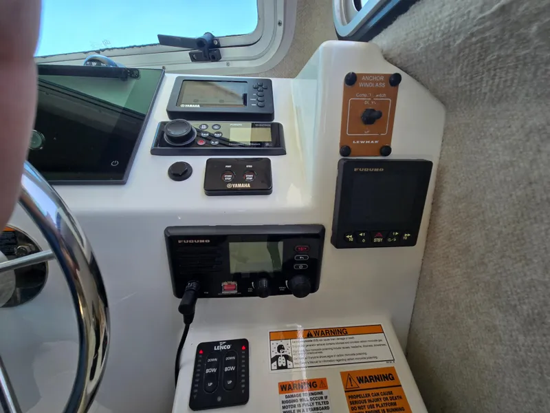 Slide: The Image of Control panel of a 2019 Parker 2520 DV boat with navigation and warning systems. - 38
