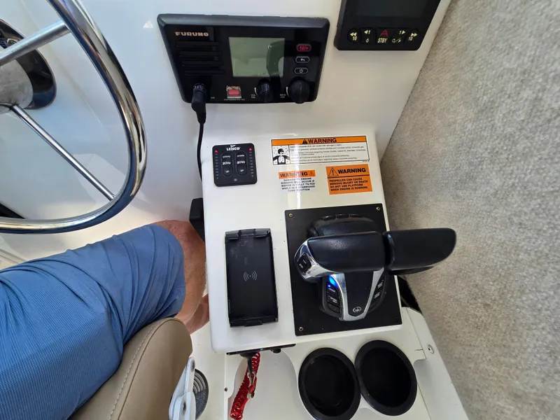 Slide: The Image of Control panel of a 2019 Parker 2520 DV boat with steering wheel and throttle. - 39