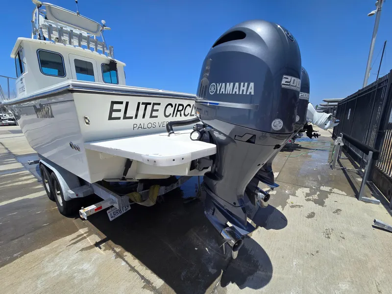 Slide: The Image of 2019 Parker 2520 DV boat with Yamaha engines, docked at a marina. - 42