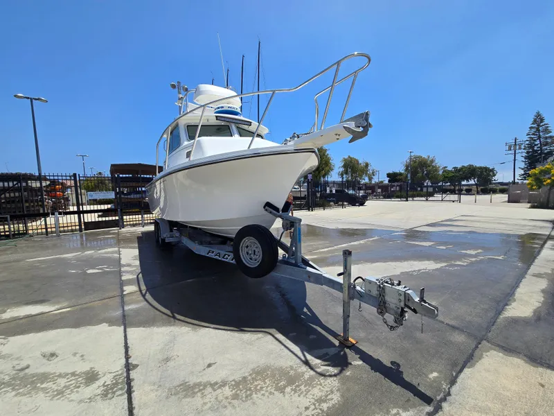 Slide: The Image of 2019 Parker 2520 DV boat on trailer in sunny marina setting. - 43