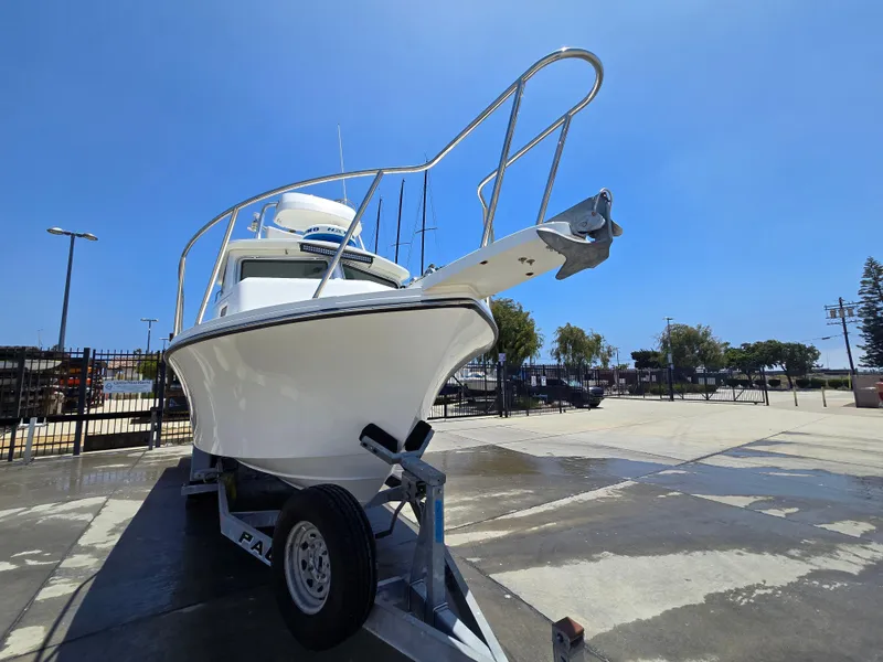 Slide: The Image of 2019 Parker 2520 DV boat on trailer in sunny outdoor setting. - 44