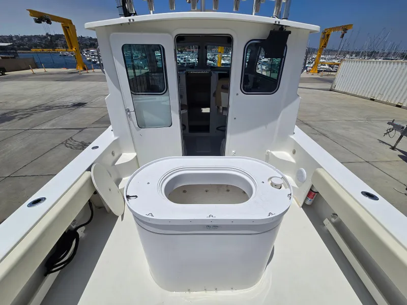 Slide: The Image of 2019 Parker 2520 DV boat with open deck and cabin, docked at marina. - 8