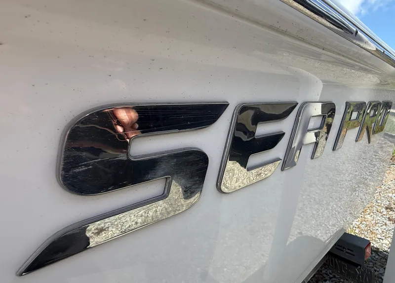 Slide: The Image of Close-up of 2018 Sea Pro 228 Bay boat logo on white hull. - 12