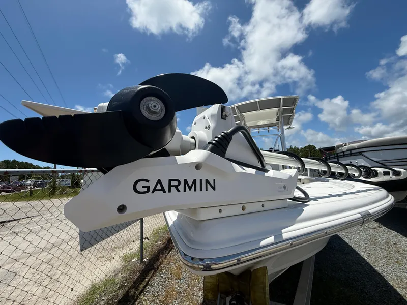 Slide: The Image of 2018 Sea Pro 228 Bay boat with Garmin trolling motor, under a clear blue sky. - 4