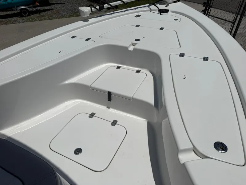 Slide: The Image of 2018 Sea Pro 228 Bay boat deck with storage compartments and clean white finish. - 6