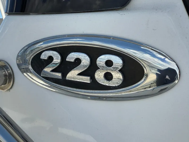 Slide: The Image of Chrome "228" emblem on a 2018 Sea Pro 228 Bay boat. - 9