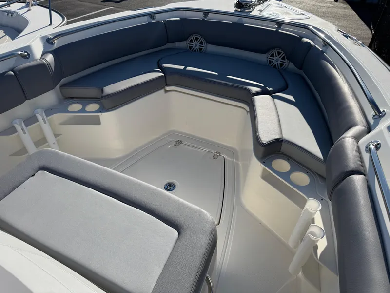 Slide: The Image of 2025 Boston Whaler 230 Outrage boat interior with cushioned seating and cup holders. - 5