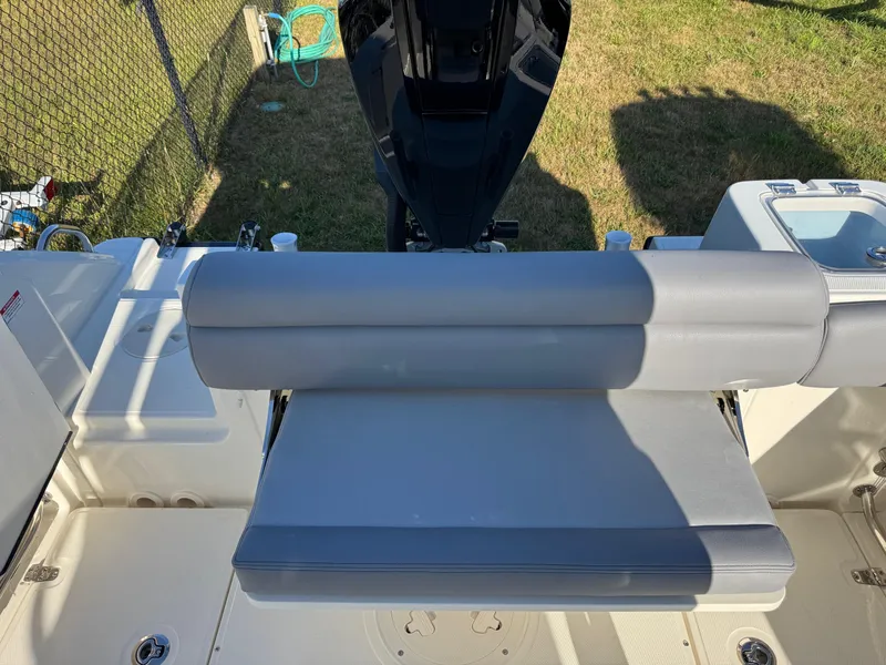 Slide: The Image of 2025 Boston Whaler 230 Outrage boat interior with cushioned seating and deck details. - 7