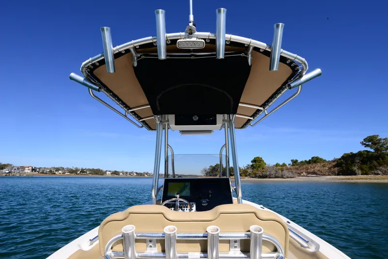 Slide: The Image of 2020 Key West 219 FS boat on water, featuring center console and rod holders. - 14