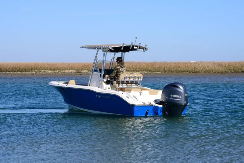 Slide: The Image of 2020 Key West 219 FS boat cruising on calm water with Yamaha outboard motor. - 5