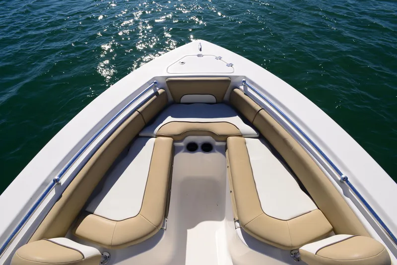 Slide: The Image of 2020 Key West 219 FS boat bow with cushioned seating on calm water. - 7