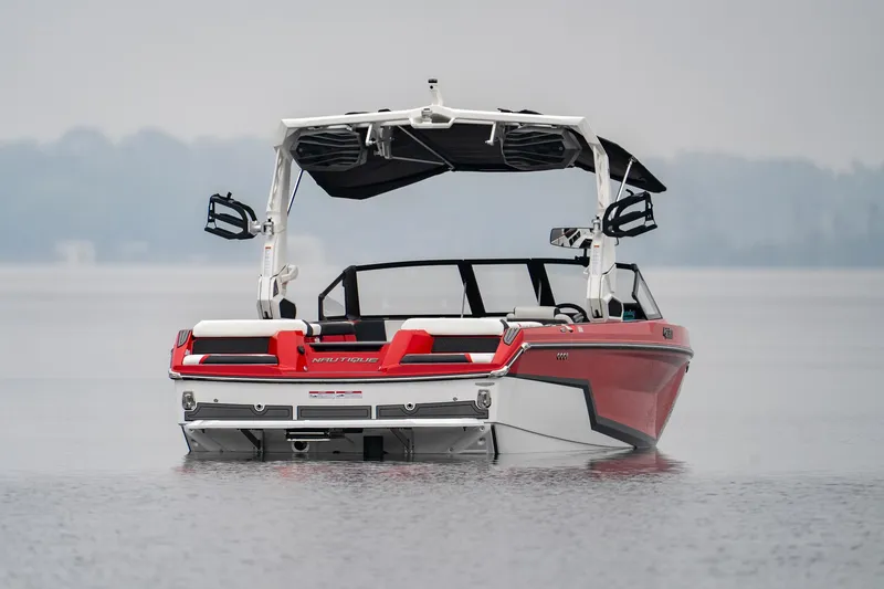 Slide: The Image of 2026 Nautique Super Air Nautique GS22 boat on calm water, rear view. - 10