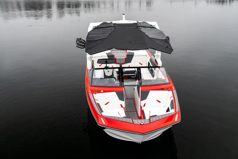 Slide: The Image of 2026 Nautique Super Air Nautique GS22 boat on calm water, featuring sleek red and white design. - 11