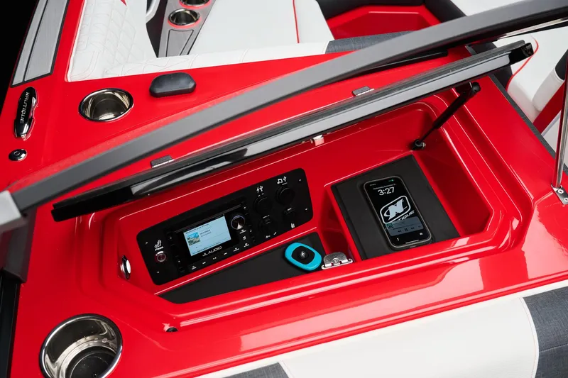 Slide: The Image of 2026 Nautique Super Air Nautique GS22 dashboard with audio system and smartphone dock. - 15