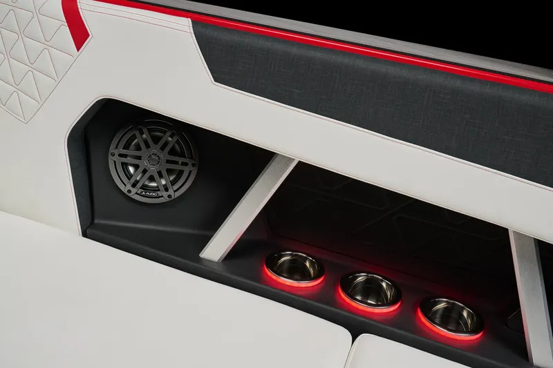 Slide: The Image of 2026 Nautique Super Air Nautique GS22 interior with speaker and illuminated cup holders. - 16