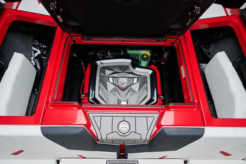 Slide: The Image of 2026 Nautique Super Air Nautique GS22 engine compartment with PCM engine, red and white interior. - 8