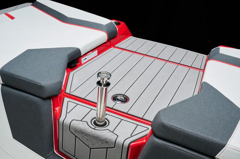 Slide: The Image of 2026 Nautique Super Air Nautique GS22 boat deck with red accents and gray upholstery. - 9