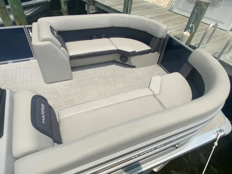 Slide: The Image of 2024 Harris Cruiser 230 pontoon boat with spacious seating and modern design. - 8