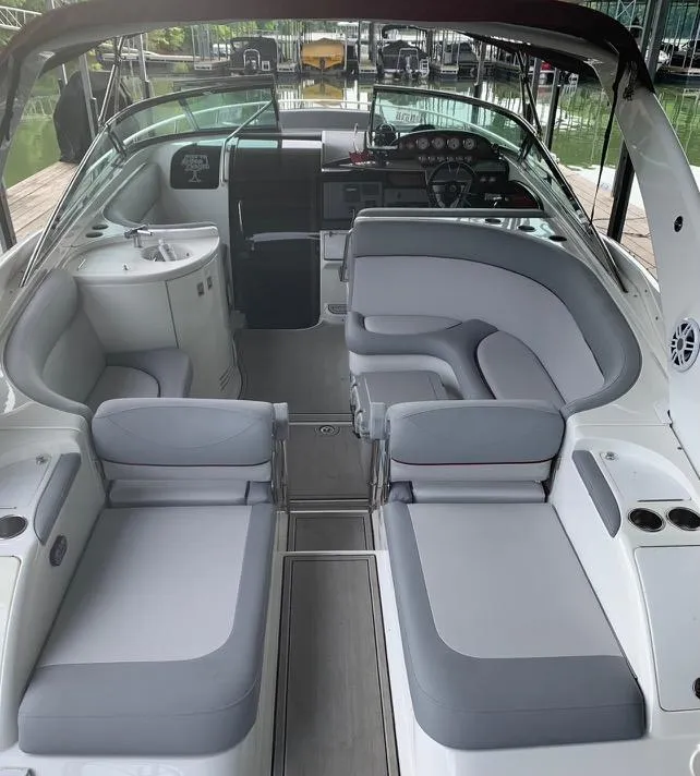 Slide: The Image of Interior of a 2005 Cobalt 360 boat with gray seating and modern dashboard. - 10