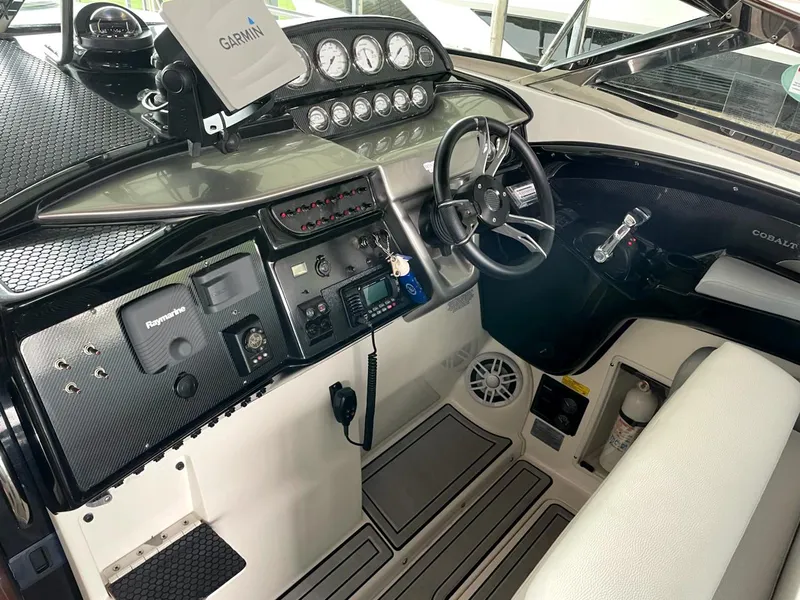 Slide: The Image of Cockpit of a 2005 Cobalt 360 boat with steering wheel and navigation equipment. - 11