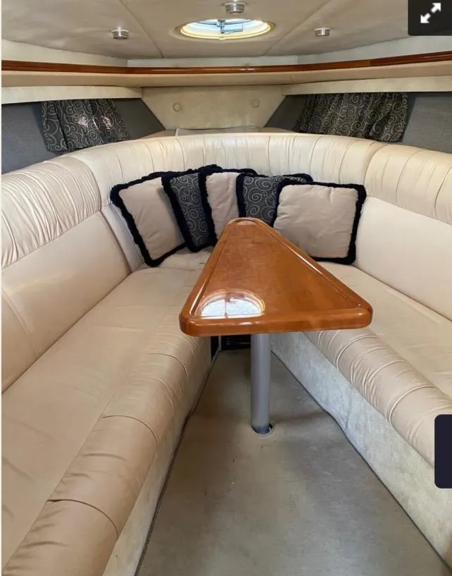 Slide: The Image of Luxurious interior of a 2005 Cobalt 360 boat with plush seating and elegant wooden table. - 15