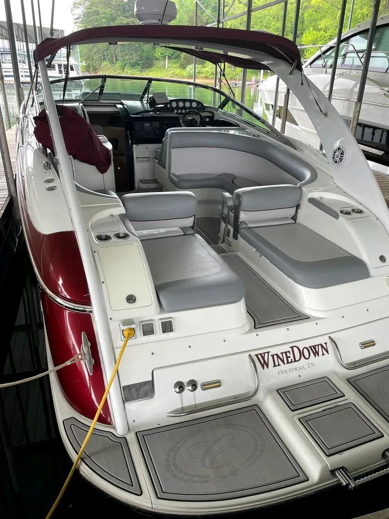 Slide: The Image of 2005 Cobalt 360 boat with red and white exterior, docked in a marina. - 5