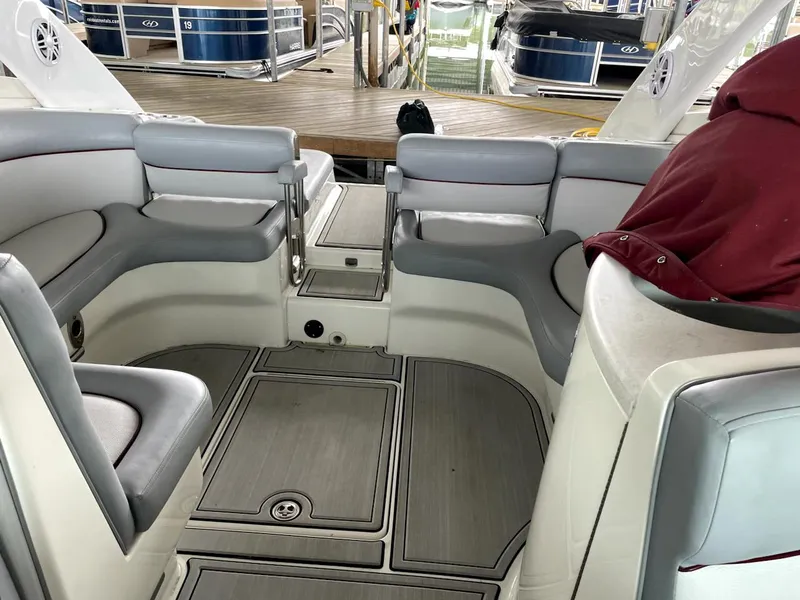 Slide: The Image of Interior of a 2005 Cobalt 360 boat with gray seating and wood flooring. - 9
