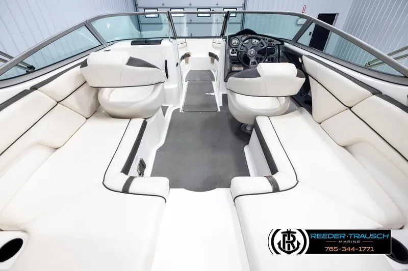 Slide: The Image of 2013 Yamaha Boats 210 SX interior with white seating and steering console. - 13