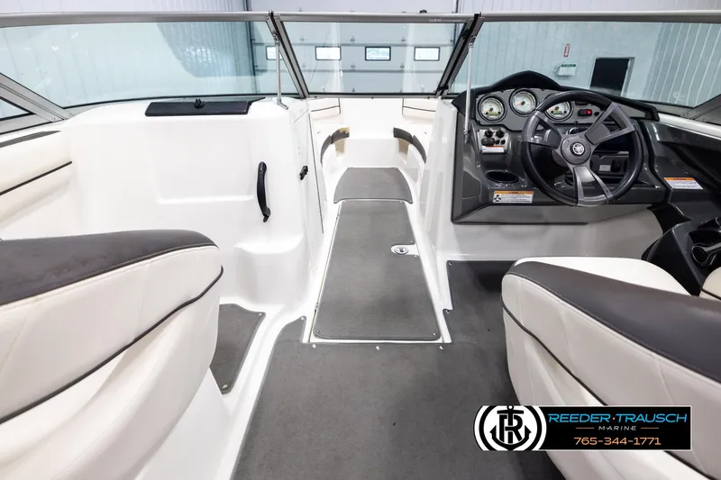Slide: The Image of Interior of 2013 Yamaha Boats 210 SX, featuring steering wheel and seating. - 14