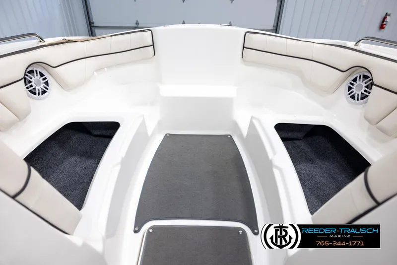 Slide: The Image of Interior of 2013 Yamaha Boats 210 SX, featuring cushioned seating and marine speakers. - 16