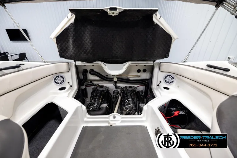 Slide: The Image of Open engine compartment of a 2013 Yamaha Boats 210 SX, showcasing dual engines. - 20