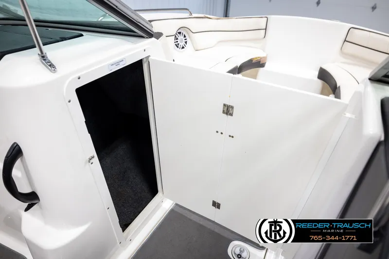 Slide: The Image of 2013 Yamaha Boats 210 SX interior with open storage compartment and seating area. - 22