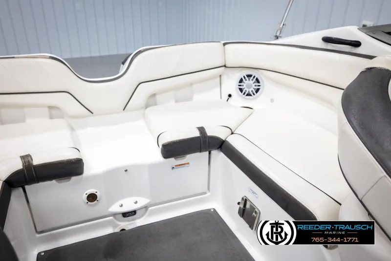 Slide: The Image of Interior of 2013 Yamaha Boats 210 SX, featuring white seating and speaker. - 23