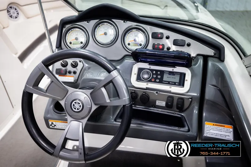 Slide: The Image of Steering console of 2013 Yamaha Boats 210 SX with gauges and controls. - 25