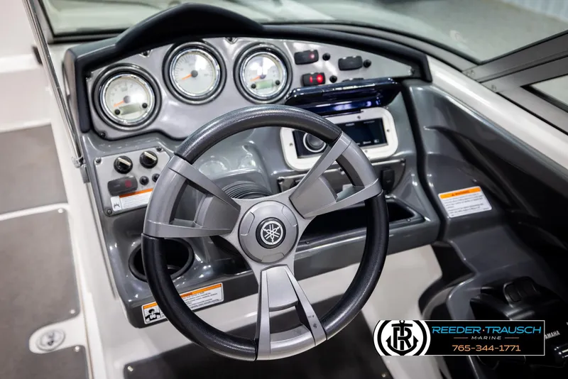 Slide: The Image of Steering console of 2013 Yamaha Boats 210 SX with gauges and controls, Reeder-Trausch Marine branding. - 26